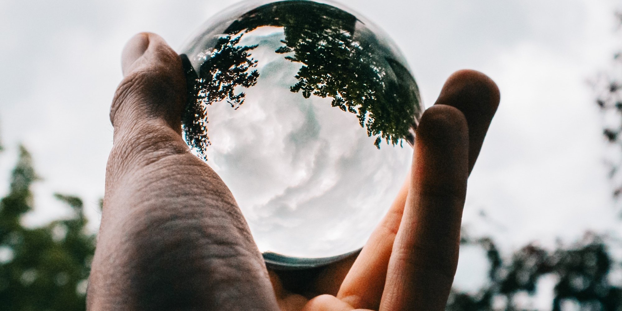 person holding glass ball with reflection case study image